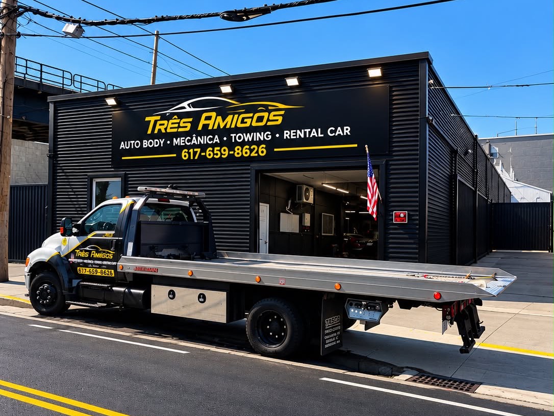 Tres Amigos Auto Body storefront on Commercial St, Lynn, with the shop's tow truck parked in front