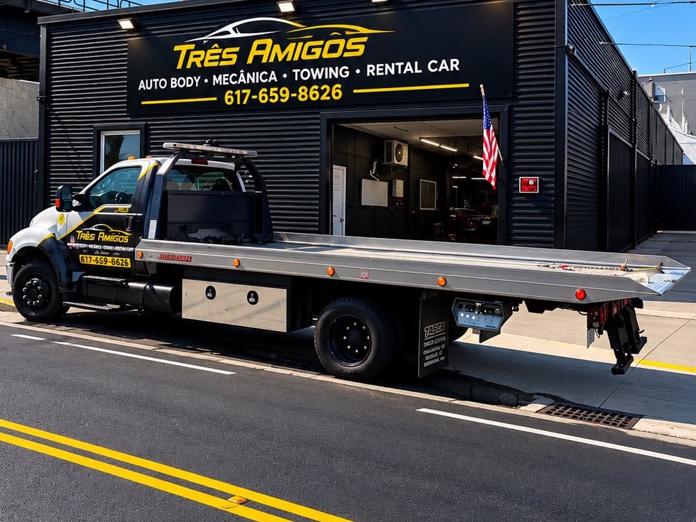 Tres Amigos Auto Body's own tow truck parked at the shop, ready for 24-hour towing