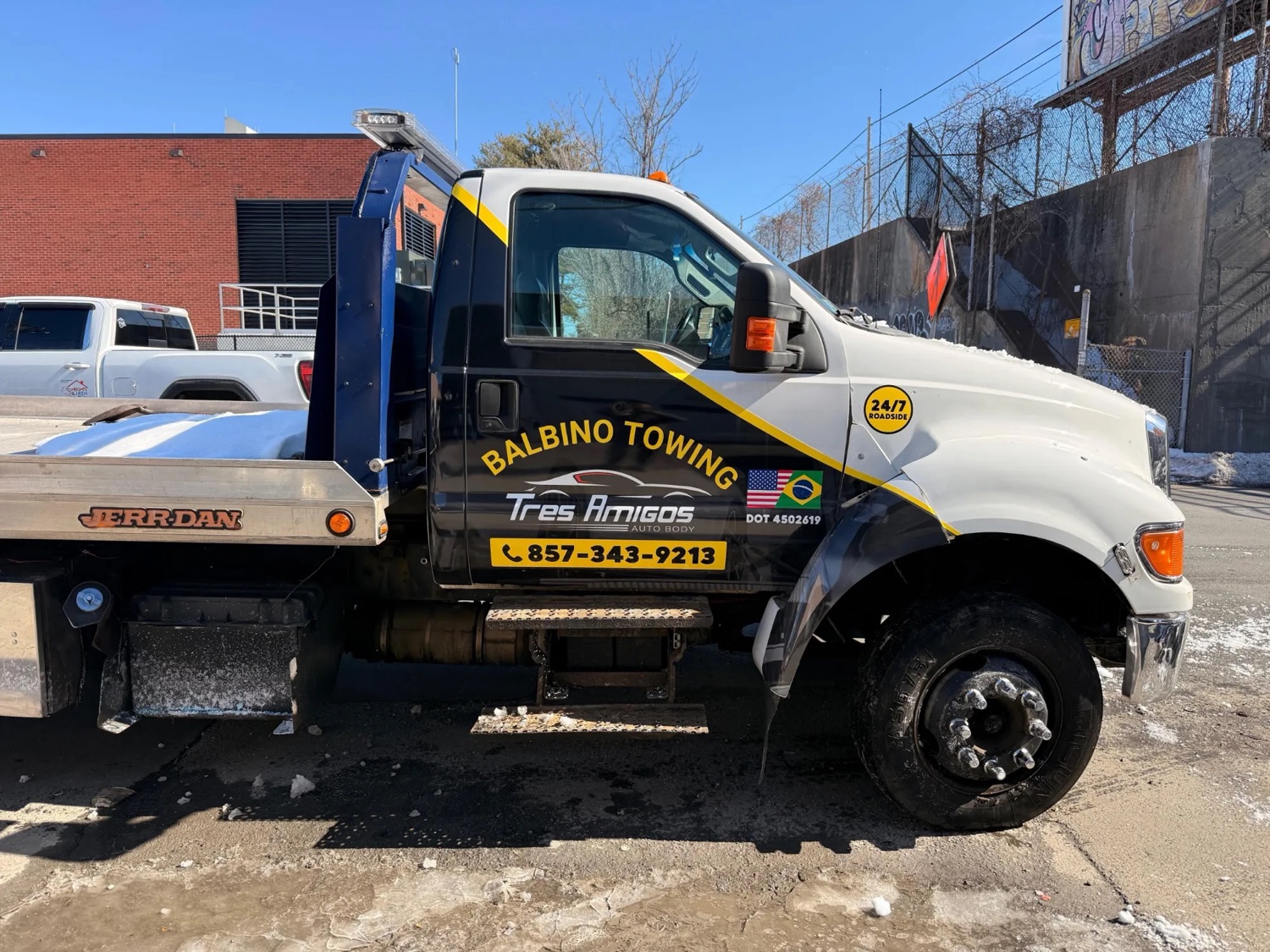 Side view of the shop's own Balbino Towing truck, in service for 24-hour towing